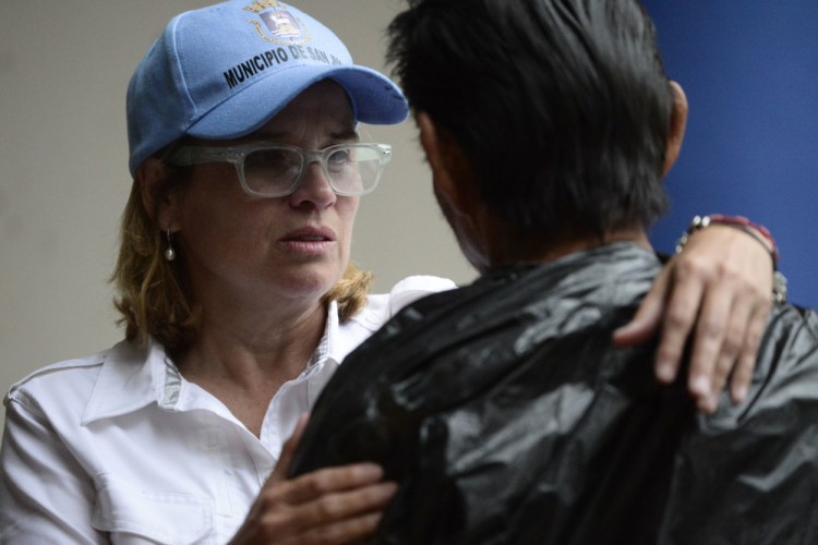 San Juan Mayor Carmen Yulin Cruz arrives at the San Francisco hospital during the evacuation of patients after an electrical plant failure, in San Juan, Puerto Rico, Saturday, Sept. 30, 2017. President Donald Trump is lashing out at the mayor of Puerto Rico's capital city in a war of words over recovery efforts after Hurricane Maria smashed into the U.S. territory. Trump is out with a series of tweets criticizing Cruz for criticizing the Trump administration's hurricane response.