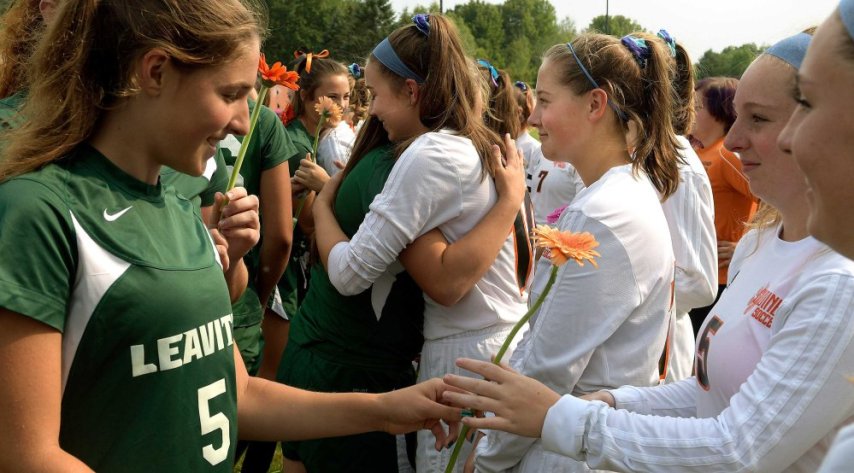 Leavitt soccer players, left, hand Gardiner players flowers before a Class B game Tuesday in Gardiner. It was the first game the Tigers played since teammate Taby Hembree died from injuries sustained in a car accident last Thursday.