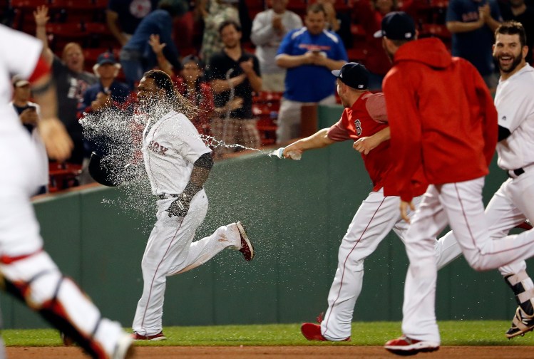Hanley Ramirez is sprayed with water and chased by Red Sox teammates after driving in the winning run with a single in the 19th inning for a 3-2 victory over the Toronto Blue Jays early Wednesday morning. 