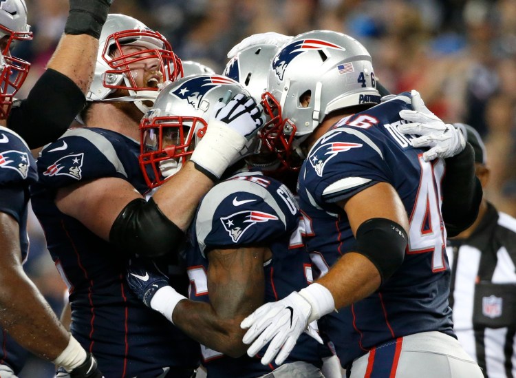 Patriots running back Mike Gillislee, center, celebrates with teammates after scoring a touchdown against the Kansas City Chiefs.
