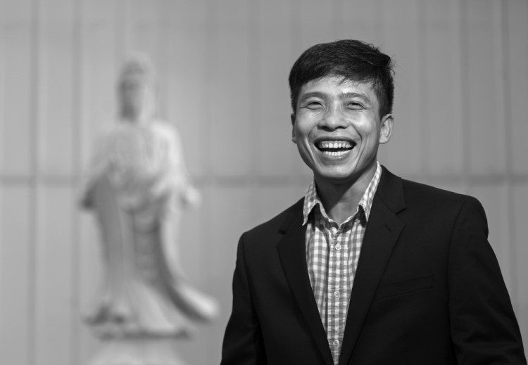 Quang Nguyen, a naturalized U.S. citizen originally from Vietnam, stands near a statue of Avalokitesvara – a bodhisattva who embodies compassion – at the Chua Hoi Duc Temple in South Portland. Nguyen was instrumental in getting the Buddhist temple established.