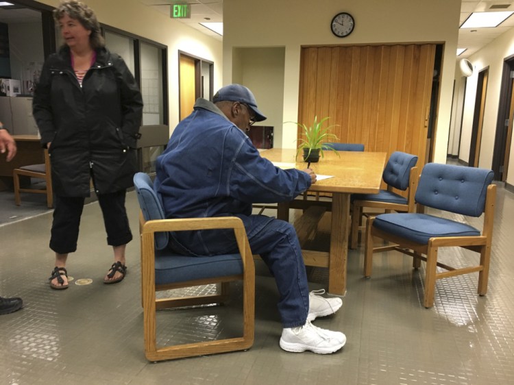 Former football legend O.J. Simpson signs documents at the Lovelock Correctional Center late Saturday. Simpson was released from the correctional center in northern Nevada early Sunday.