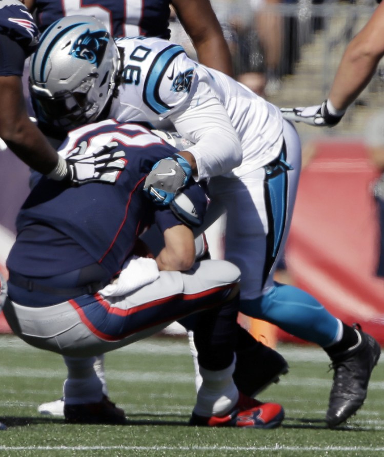 Carolina Panthers defensive end Julius Peppers sacks New England Patriots quarterback Tom Brady during the first half Sunday in Foxborough, Mass.