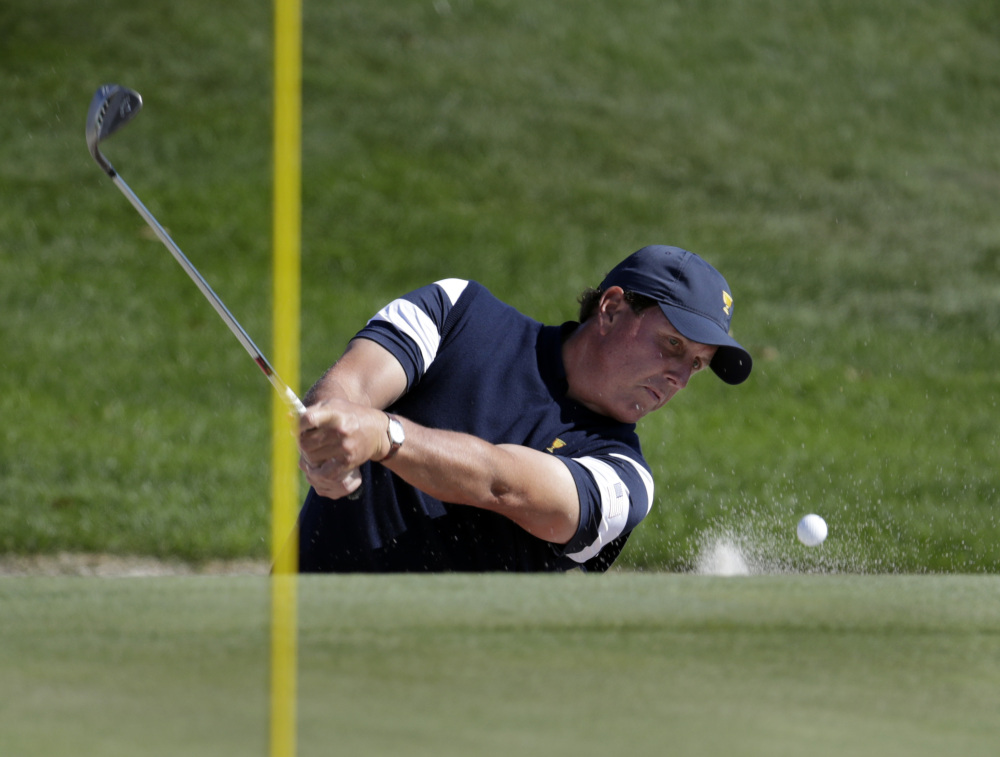 Phil Mickelson chips out of a bunker on the third hole during the final round at Liberty National Golf Club in Jersey City, N.J., on Sunday.