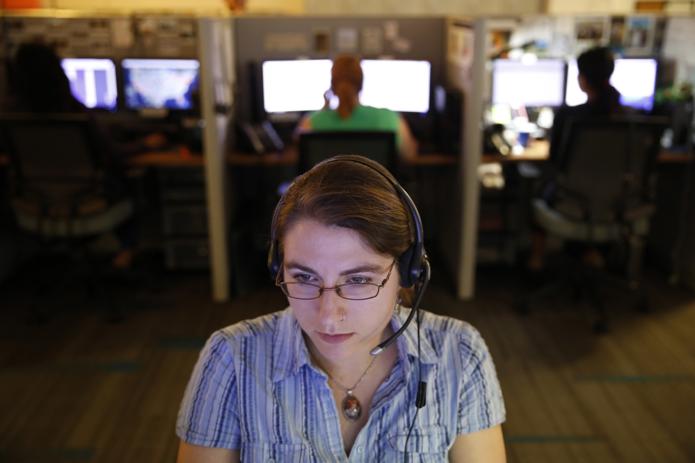 An advocate takes a call from a potential victim of trafficking while working at the Human Trafficking Hotline call center.