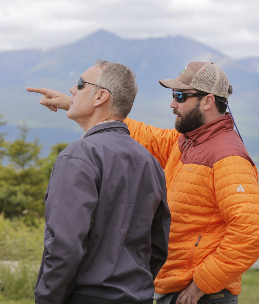 KATAHDIN WOODS AND WATERS NATIONAL MONUMENT, ME - JUNE 14: With Mount Katahdin in the background, Lucas St. Clair, right, points out features in the landscape to Interior Secretary Ryan Zinke, during a tour of the Katahdin Woods & Waters National Monument on Wednesday, June 14, 2017. Zinke was touring the monument because it is one of dozens of monuments up for review under an executive order from President Trump. St. Clair's family donated the land for the monument to the National Park Service last year.