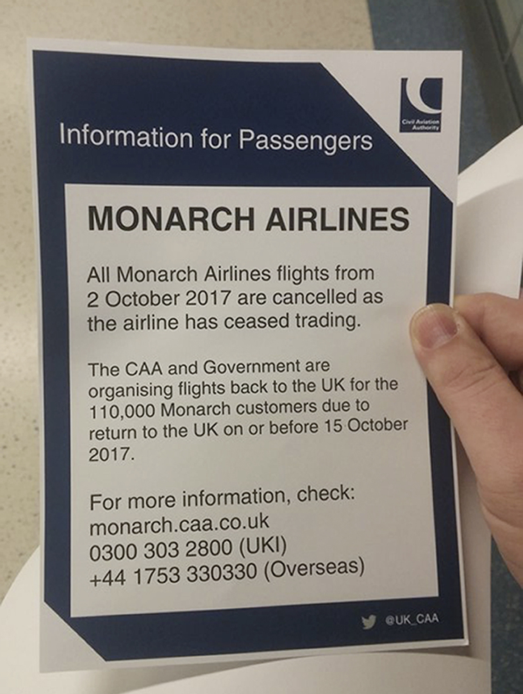 A notice for troubled British carrier Monarch Airlines passengers is seen at London's Gatwick Airport on Monday. Monarch Airlines has suspended all flights.