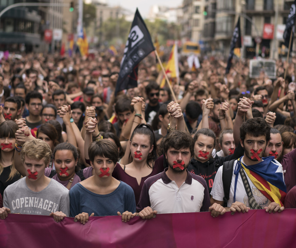 Independence supporters march in Barcelona on Monday. The Spanish government has praised its security forces' actions, including shooting rubber bullets, during Sunday's voting.