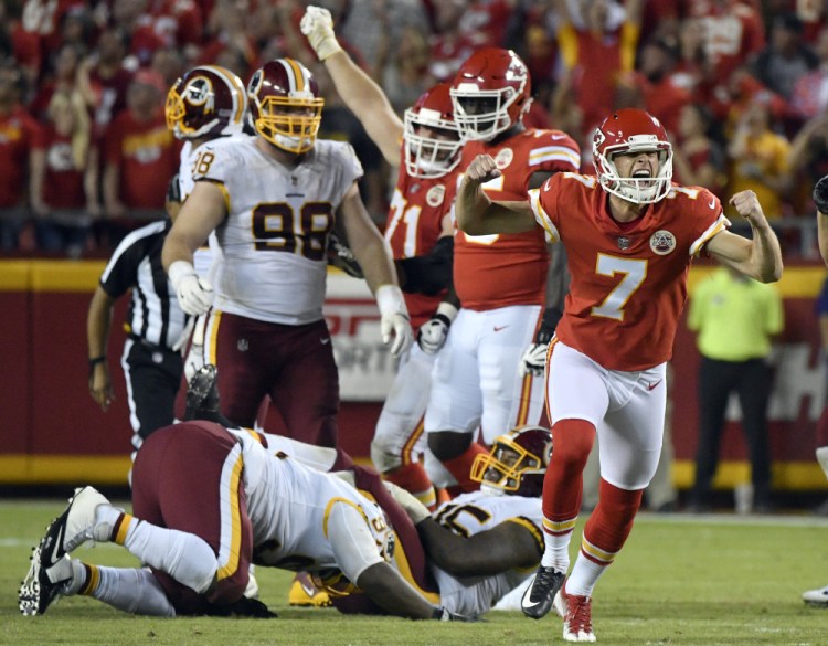 Harrison Butker, right, celebrates Monday night after kicking a go-ahead field goal with eight seconds left that paved the way for a 29-20 victory against Washington, making the Kansas City Chiefs the final undefeated team in the NFL.