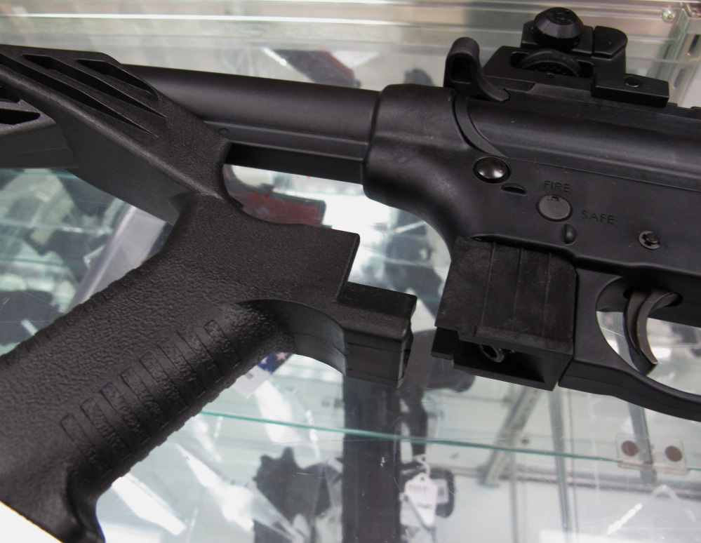 Bump stocks such as this one next to a disassembled .22-caliber rifle have been around since the government approved their sale in 2010.