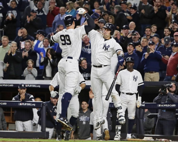 The Yankees' Aaron Judge celebrates with Gary Sanchez after hitting a two-run home run in the fourth inning Tuesday night in New York.