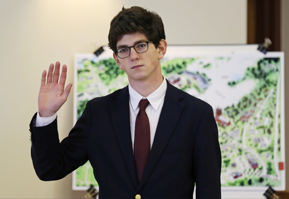  St. Paul's School graduate Owen Labrie raises his hand to be sworn-in prior to testifying in his trial at Merrimack Superior Court in Concord, N.H. in 2015. 