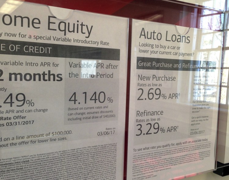 Home equity and auto loan rates are displayed at a bank in North Andover, Mass. Consumer borrowing slowed in August.