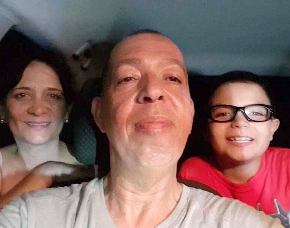 The Cruz family of Arecibo, Puerto Rico, is shown in a selfie photo taken in their vehicle after Hurricane Maria struck the island. From left are Ana Montijo, Angel Cruz and Luis Cruz.
