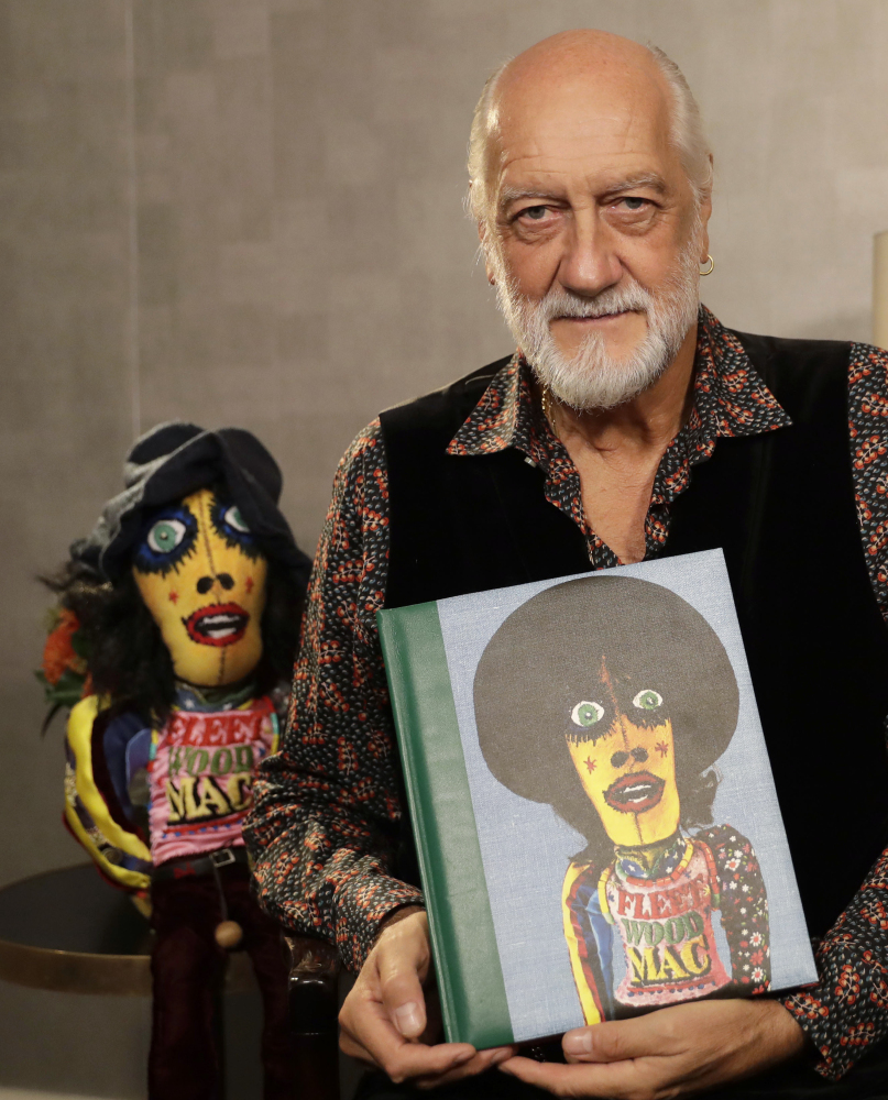 Mick Fleetwood holds a copy of "Love That Burns: A Chronicle of Fleetwood Mac, Volume One: 1967-1974."