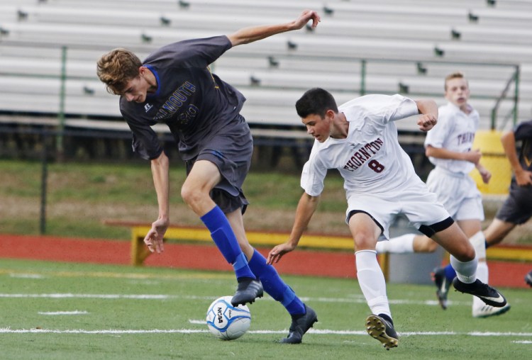 Nick Hester of Falmouth attempts to settle the ball as Eric McCallum of Thornton Academy looks to take it away Friday during the first half of Falmouth's 5-3 victory in an SMAA game at Saco.