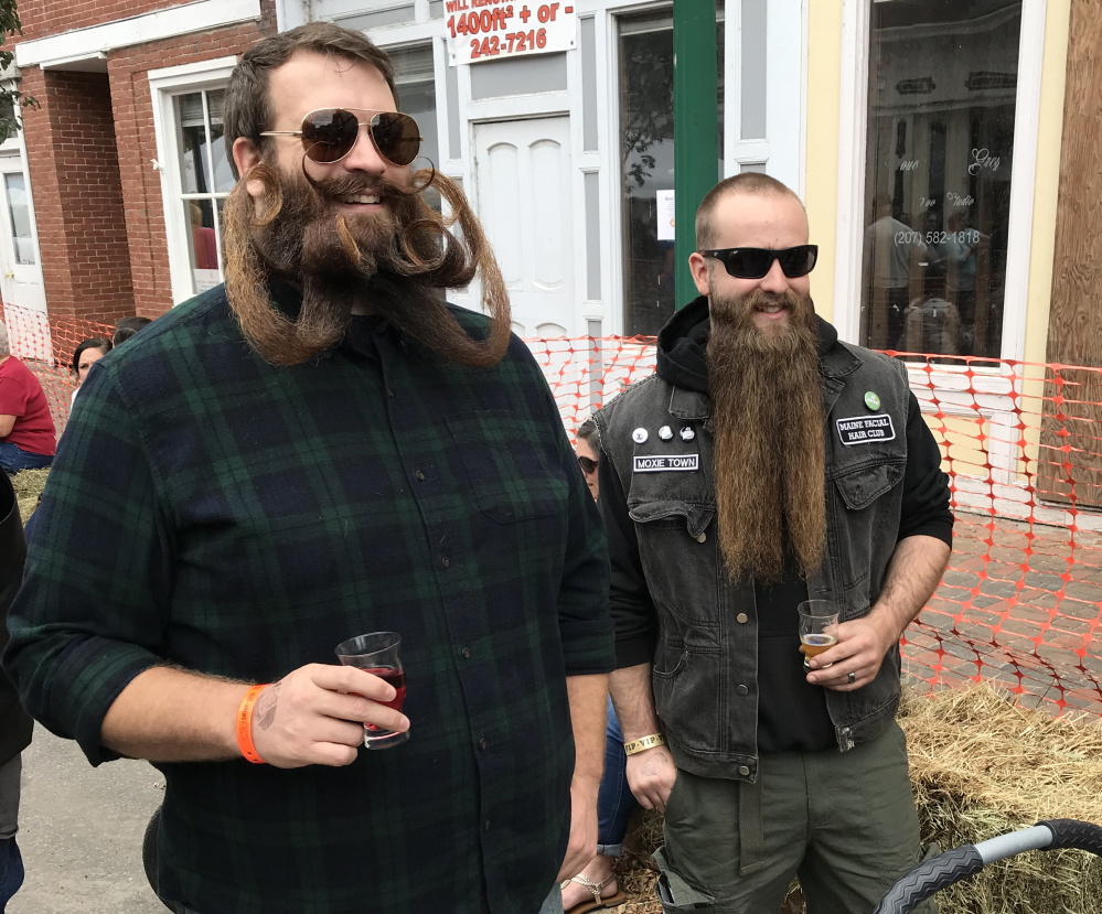 Bryce Royal, left, and Zachary LeClair show off their whiskers during the eighth annual Swine & Stein Oktoberfest in Gardiner on Saturday.
