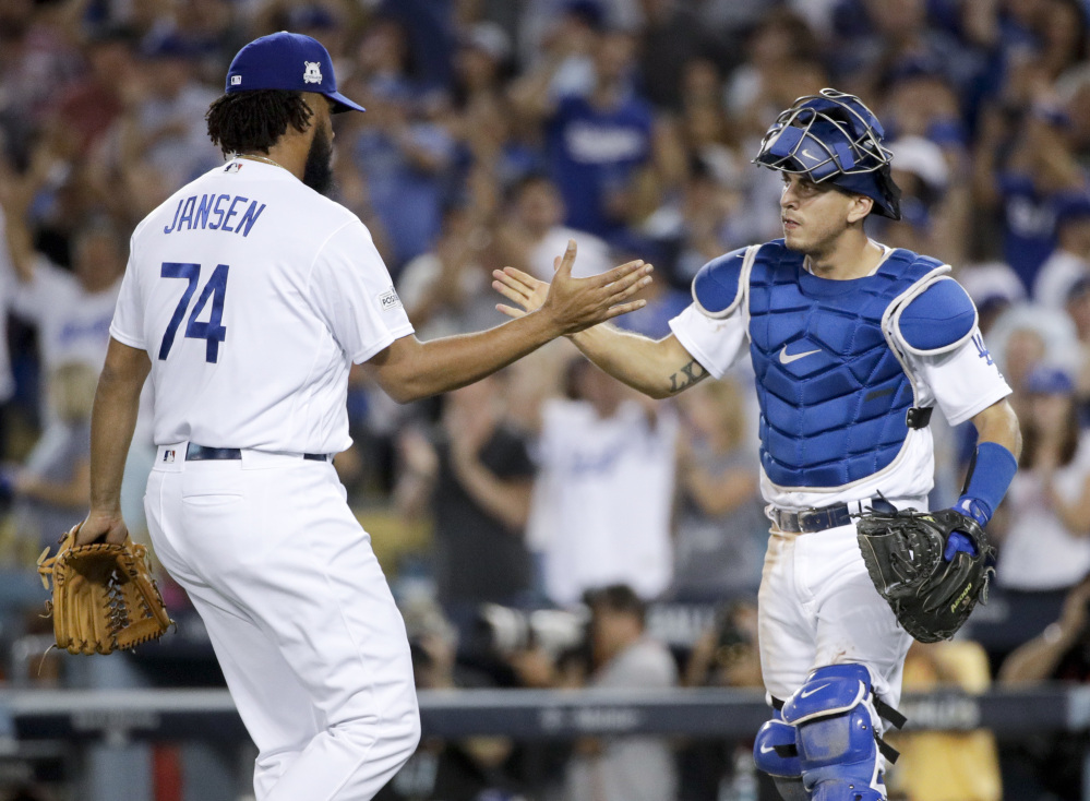 Dodgers catcher Austin Barnes and relief pitcher Kenley Jansen celebrate after their win against the Diamondbacks.