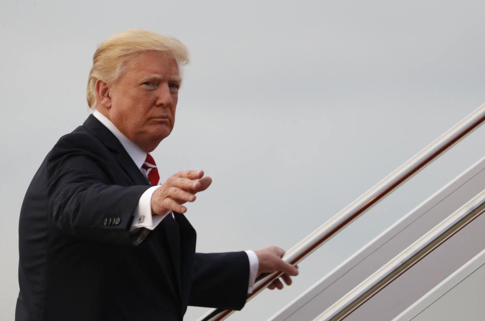 President Trump waves as he boards Air Force One on Saturday en route to a fundraiser in Greensboro, N.C.