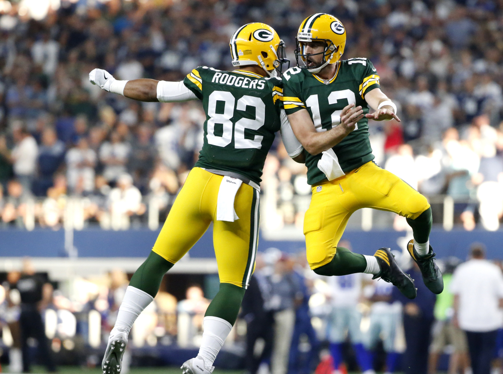 Packers tight end Richard Rodgers and quarterback Aaron Rodgers celebrate a late TD catch by Davante Adams that propelled Green Bay to a 35-31 win over the Cowboys.