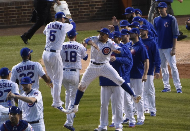 The Cubs' Albert Almora Jr. and Javier Baez celebrate their win in Game 3 of the National League Division Series on Monday in Chicago. The Cubs won 2-1 to take a 2-1 lead in the series.