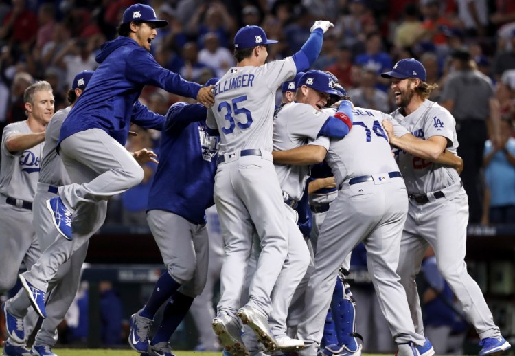 The Dodgers celebrate Monday night after sweeping the Diamondbacks in the NL division series with a 3-1 win. The Dodgers advance to the NLCS and will meet either Washington or Chicago.