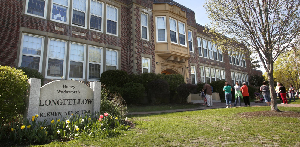 Students exit Longfellow Elementary in 2013. The discovery of mold in the school has galvanized supporters of plans to renovate the city's elementary schools.
