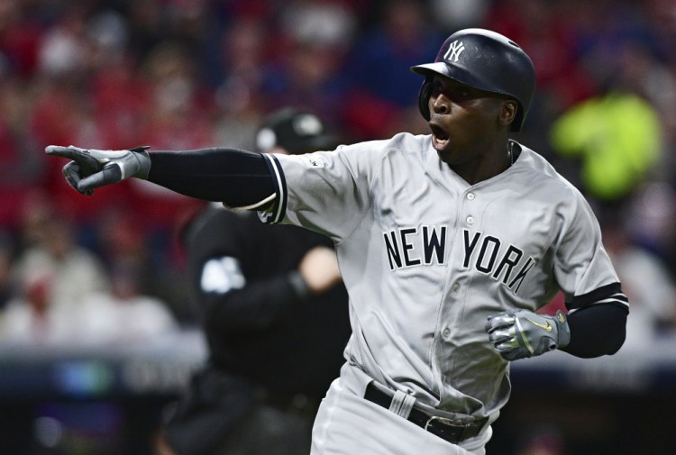 Didi Gregorius points to the dugout after hitting a two-run home run off Corey Kluber in the third inning of Game 5 of a baseball American League division series Wednesday night in Cleveland.