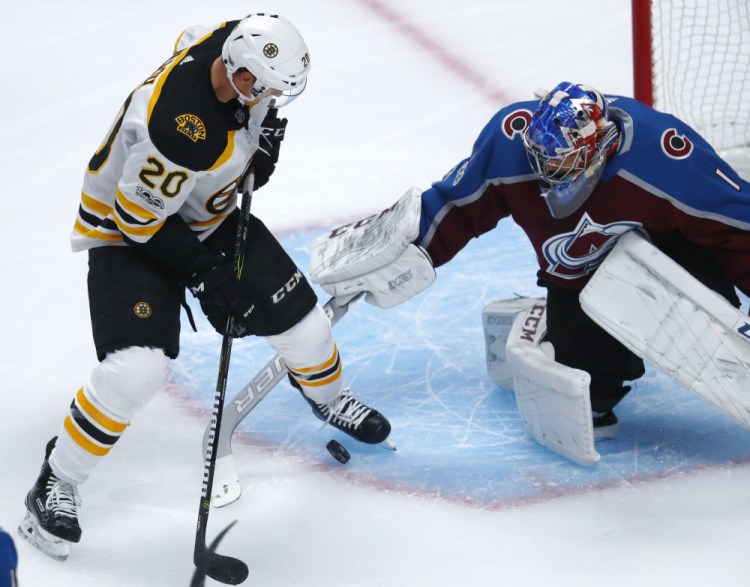 Bruins center Riley Nash tries to redirect a shot past Colorado goalie Semyon Varlamov in the first period Wednesday night in Denver.