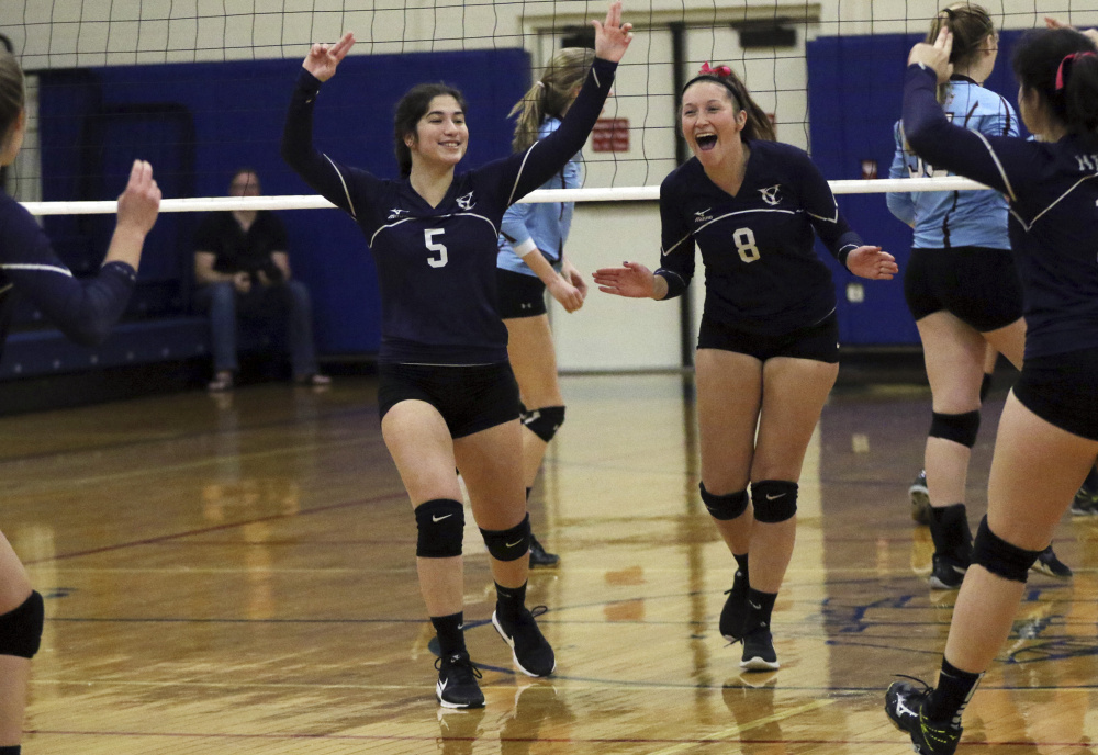 Yarmouth's Morgan Cooper, left, and Nora Laprise celebrate after the Clippers won a point on their way to a 25-19, 26-24, 25-16 victory.