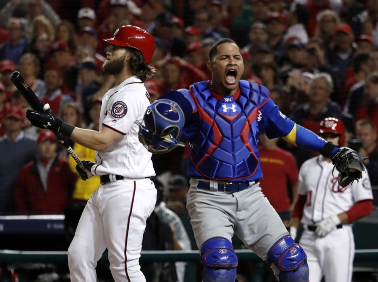 Cubs catcher Willson Contreras leaps after the Nationals' Bryce Harper struck out for the final out as the Cubs beat Washington 9-8 to to win their National League Division Series early Friday.