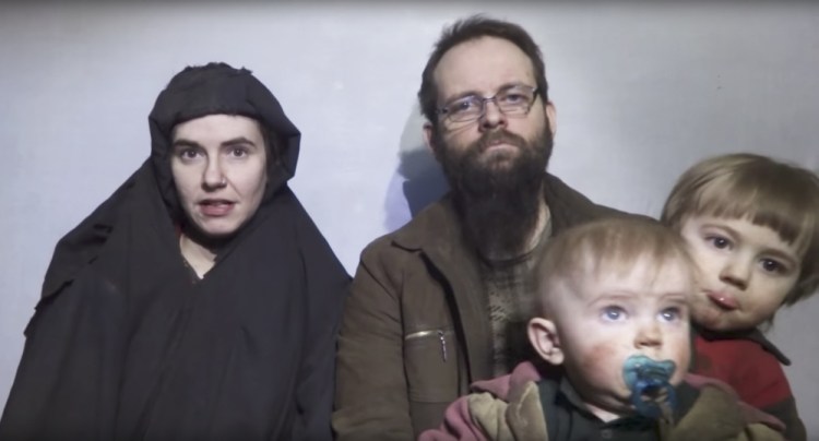 Caitlan Coleman and Joshua Boyle appear with two of their children in a video recorded by their captors in 2016. After being held for five years, the family was freed Wednesday.