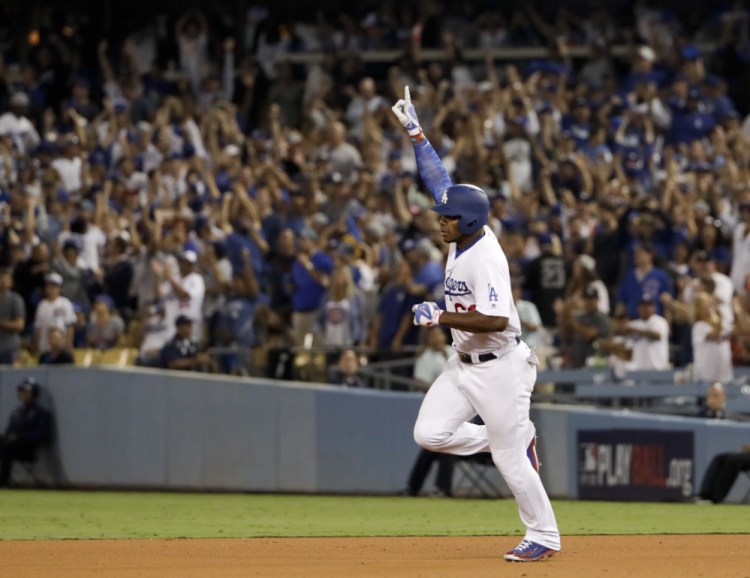 Los Angeles Dodgers Yasiel Puig celebrates his home run against Chicago during the seventh inning on Saturday night.