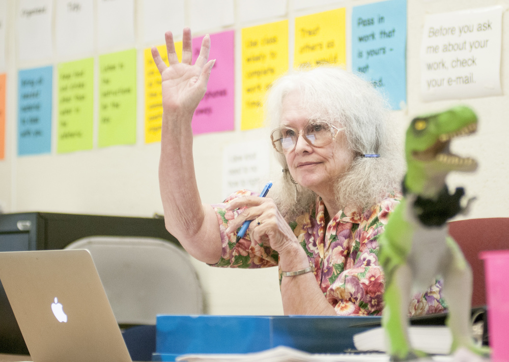 Phyllis McDonough, 72, helps freshmen review for a test in her Western Civilization class at Hall-Dale High School in Farmingdale. Her classroom's mascot is a T. Rex, on her desk above, because student joke that she's been around since the age of the dinosaur.
