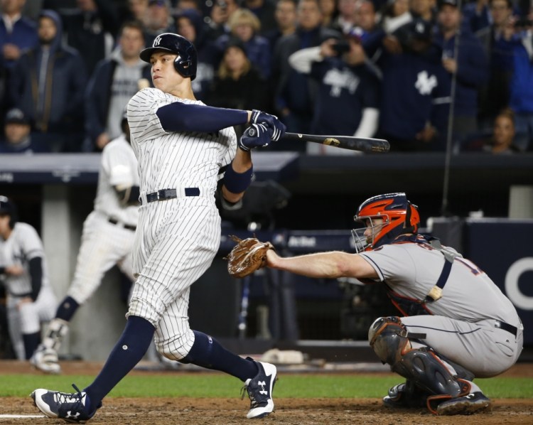 Aaron Judge connects for a three-run homer in the fourth inning of Game 3 of the ALCS on Monday night in New York, helping the Yankees open an 8-0 lead over the Astros. New York won 8-1 to cut Houston's lead to 2-1 in the best-of-seven series.