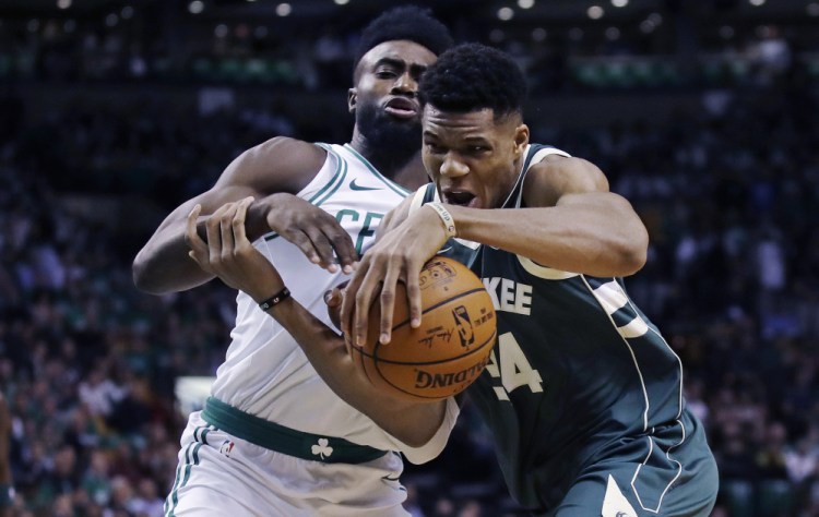 Milwaukee's Giannis Antetokounmpo, right, tries to drive past Boston's Jaylen Brown in the first quarter of Wednesday night's game at Boston.