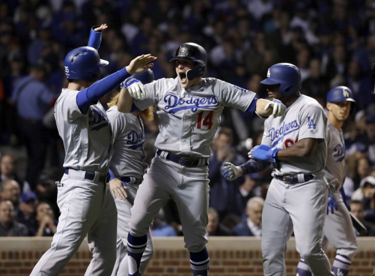 Enrique Hernandez of the Dodgers celebrates after hitting a grand slam in the third inning Thursday night in Chicago.