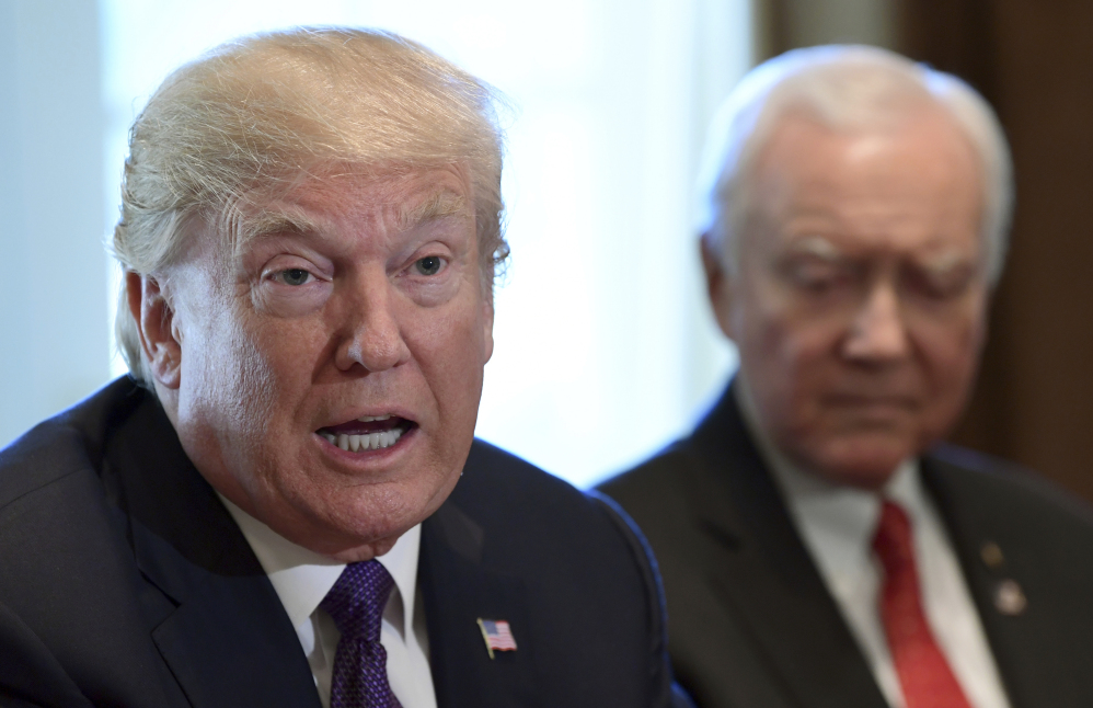 President Trump, shown Wednesday with Sen. Orrin Hatch, boasted in a Friday tweet about Senate passage of his budget late Thursday, 51-49.
