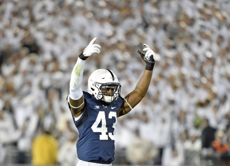 Penn State's Manny Bowen celebrates after sacking Michigan quarterback John O'Korn during the second half Saturday night in State College, Pa.