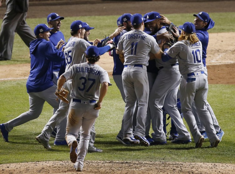 Los Angeles Dodgers players celebrate after winning Game 5 of the NL Championship Series to eliminate the Chicago Cubs last Thursday. The Dodgers are in the World Series for the first time since 1988 after winning a major league-high 104 games and cruising through the NL playoffs.