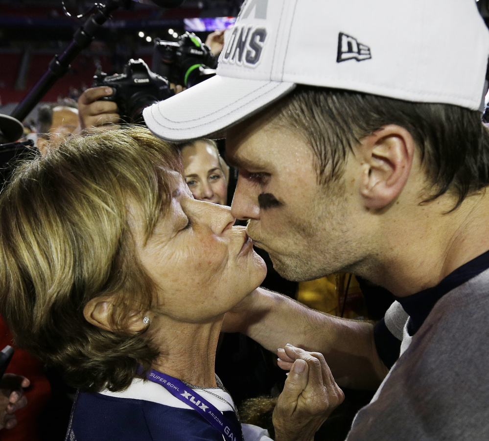 Patriots quarterback Tom Brady, right, kisses his mother Galynn after winning the Super Bowl last February.