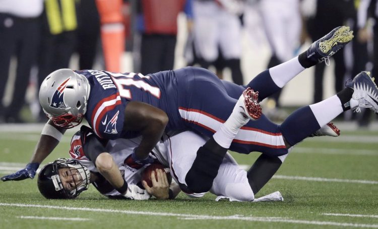 Patriots defensive tackle Adam Butler sacks Atlanta quarterback Matt Ryan in Sunday night's game. New England held Ryan to 233 passing yards in the game, the first time this season an opposing quarterback has not surpassed 300 yards against New England.