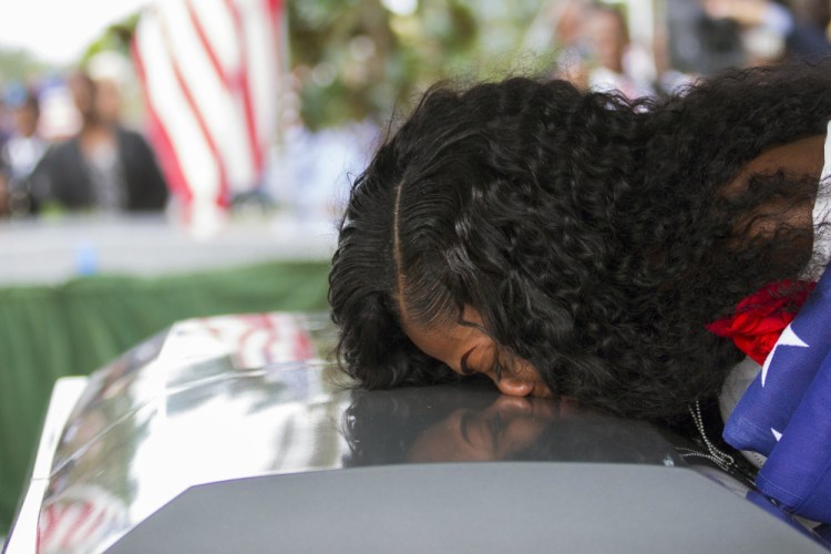 Myeshia Johnson kisses the casket of her husband, Sgt. La David Johnson during his burial service at Fred Hunter's Hollywood Memorial Gardens in Hollywood, Fla. Myeshia Johnson told ABC's "Good Morning America" on Monday that she has nothing to say to the president, adding that his phone call to her made "me cry even worse."