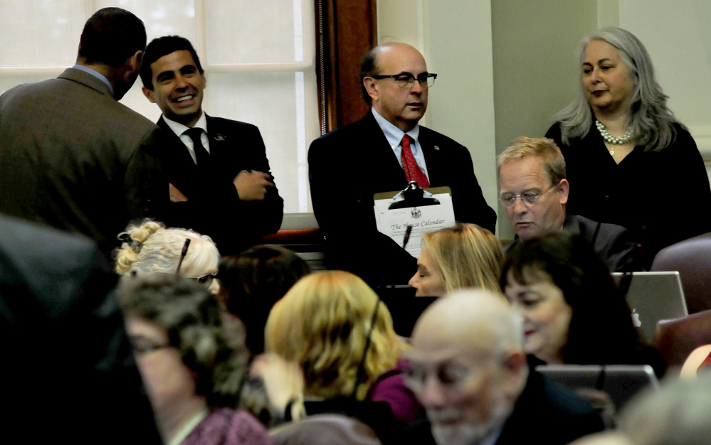 Secretary of State Matthew Dunlap, center, listens in on Monday's special session in the House. He said he never took a position against ranked-choice voting but provided information to lawmakers about how it could be implemented and what might happen in the event of a court challenge.
