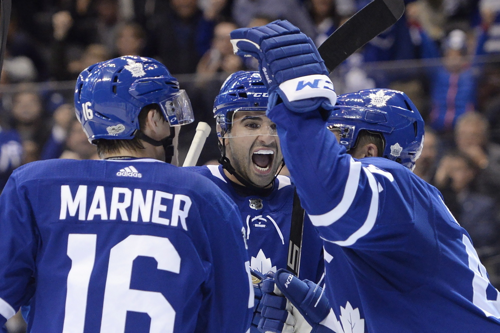Maple Leafs center Nazem Kadri, middle, celebrates a second-period goal in Toronto's' 3-2 victory over the Los Angeles Kings on Monday in Toronto.