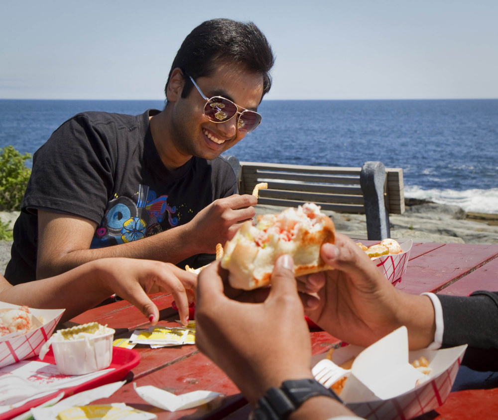 Yogesh Kauntia dines at Two Lights Lobster Shack in Cape Elizabeth in 2014. Next year, a single trade group will represent restaurants and lodging interests in an industry that had combined revenue of $3.5 billion in 2016.