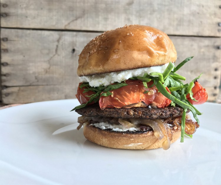 Shown topped with roasted tomatoes and vegan ricotta, the Freshiez burger is made from organic mushrooms, potatoes, onions, black beans, olive oil, oats and garlic. Look for it in local markets and on restaurant menus.