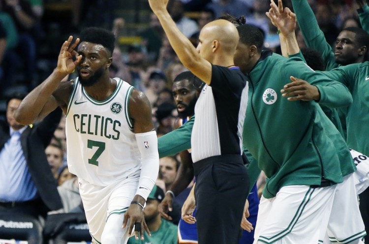Boston’s Jaylen Brown, left, celebrates a first-quarter 3-pointer during the Celtics 110-89 win at home against the New York Knicks on Tuesday night. Brown had a team-high 23 points.