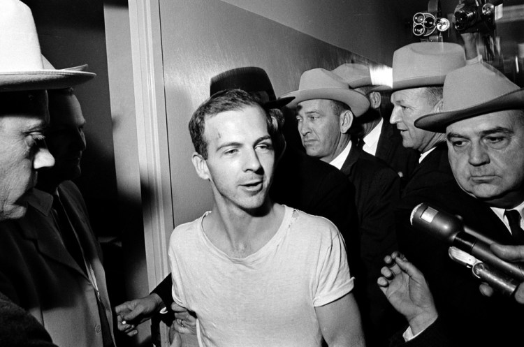 Surrounded by detectives, Lee Harvey Oswald talks to the media as he is led down a corridor of the Dallas police station for another round of questioning in connection with the assassination of President John F. Kennedy on Nov. 23, 1963. Some of the newly released documents could pertain to Oswald's six-day trip to Mexico just prior to the assassination.