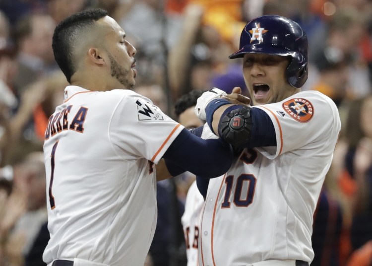 Houston's Yuli Gurriel is congratulated by Carlos Correa after hitting a home run in the second inning Friday night in Houston in Game 3 of the World Series.